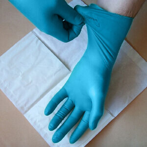 Hands wearing blue gloves
