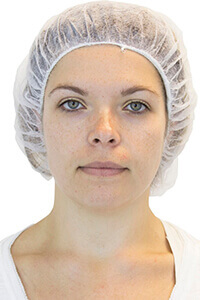 Woman wearing white bouffant cap.